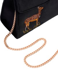 Black suede handbag featuring an embroidered deer design, with a shiny rose gold chain strap and a structured, triangular silhouette.