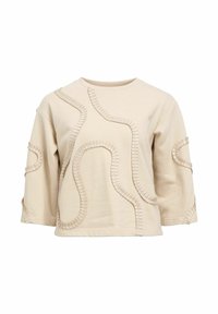Sweat-shirt beige à coupe ample, col rond et manches trois-quarts. Présente des accents de coutures texturées et incurvées sur la surface.