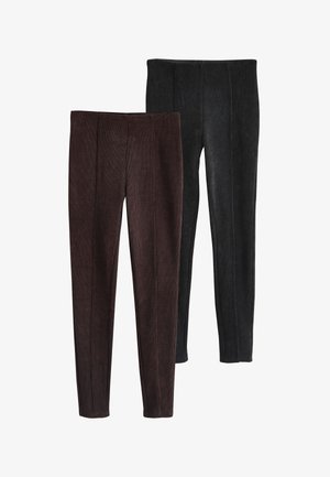 Divas pāru ribotas adītas legingi brūnā un melnā krāsā ar priekšpuses šuvju detaļām, attēlotas plakani uz balta fona.