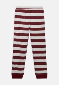 Gestreepte pyjamabroek in bordeauxrood en wit. Heeft een elastische tailleband en smalle boorden. Gemaakt van zachte, ademende stof.