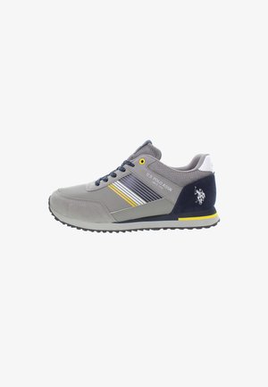 Grey sneakers with mesh and leather material, featuring yellow and white stripes, navy accents, black sole, and an embroidered logo on the heel.