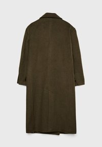 Lange, donkergroene wollen jas met een kraag, lange mouwen en zijzakken. Heeft een rechte snit met een licht gestructureerde afwerking.