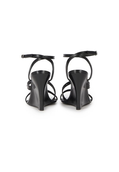 Pair of black wedge-heeled sandals with ankle straps and multiple front straps, shown from the back on a white background.