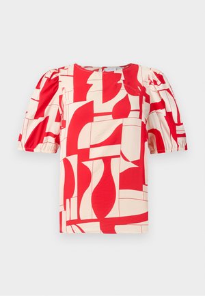 Punane ja kreemikas lühikeste varrukatega pluus julge geomeetrilise mustriga. Omab puffvarrukaid ja ümmargust kaelust, valmistatud pehmest kangast.