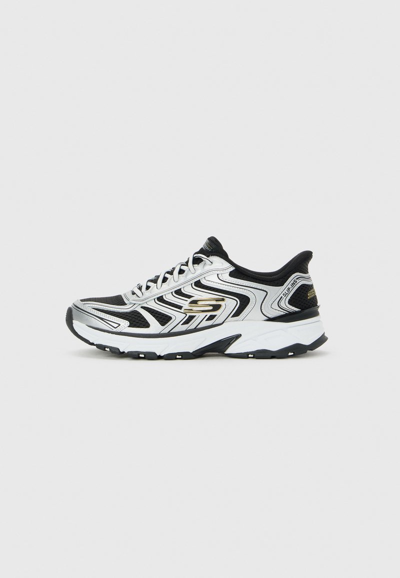 Black and silver Skechers athletic sneaker with white midsole, textured sole, lace-up design, and branded side and heel details.