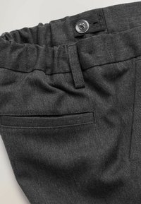 Gray fabric pants featuring a gathered waistband, a button closure, and a back pocket with a horizontal opening. Smooth texture and subtle pattern.