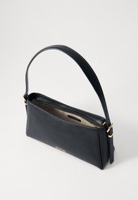 Black leather handbag with a smooth texture, a curved shape, and a gold-tone zipper. Adjustable strap and minimalist interior visible.