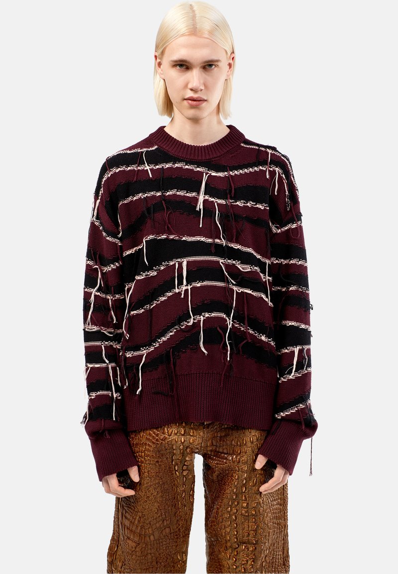 Maglione a righe bordeaux e nero lavorato a maglia con orli sfilacciati e fili pendenti, dotato di scollo rotondo e vestibilità comoda. Dettaglio in tessuto testurizzato.