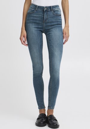 Hochtaillierte, enganliegende Jeans in hellblauem Denim mit Ausbleichungen, ausgestattet mit zwei vorderen Taschen und einem Reißverschluss mit Knopfverschluss; schlanker Schnitt.