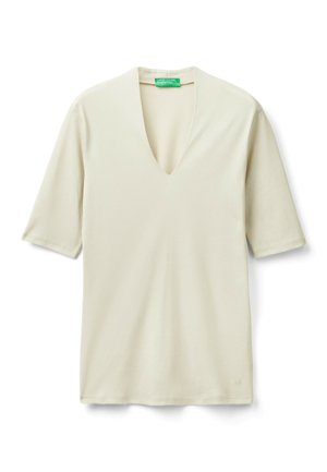 Cream-colored, short-sleeve V-neck shirt with a green United Colors of Benetton label inside the collar, laid flat on a white background.