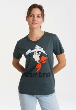 Dark gray short-sleeve t-shirt featuring a graphic of a cowboy with a white hat and red bandana, with "LUCKY LUKE" printed below.