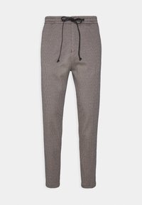 Spodnie w wzór houndstooth w kolorze szarym i czarnym, z elastycznym paskiem w talii z regulowanym sznurkiem, zwężającymi się nogawkami i mankietami u kostek.