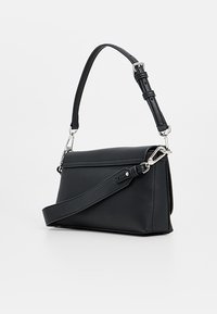 Bolso negro de hombro hecho de material liso. Presenta un diseño estructurado, correa ajustable y detalles metálicos.