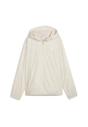 Veste coupe-vent beige clair avec capuche, fermeture éclair à l'avant, poignets élastiques et deux poches latérales. Présente un petit logo blanc sur la poitrine.