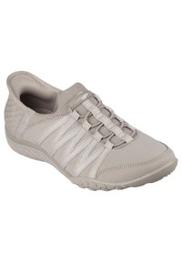 Chaussure de sport gris clair avec une tige en tissu respirant, des lacets élastiques et un talon texturé. Dotée d'une semelle en caoutchouc flexible pour une meilleure adhérence.