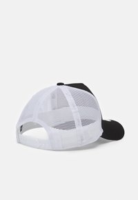 Black and white baseball cap with a solid front, mesh back, adjustable strap, and a curved peak. Features a logo on the front.