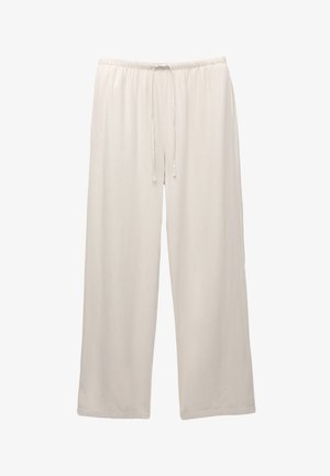 Light-colored, wide-leg trousers made from soft fabric with an elastic waistband and adjustable drawstring for comfort.