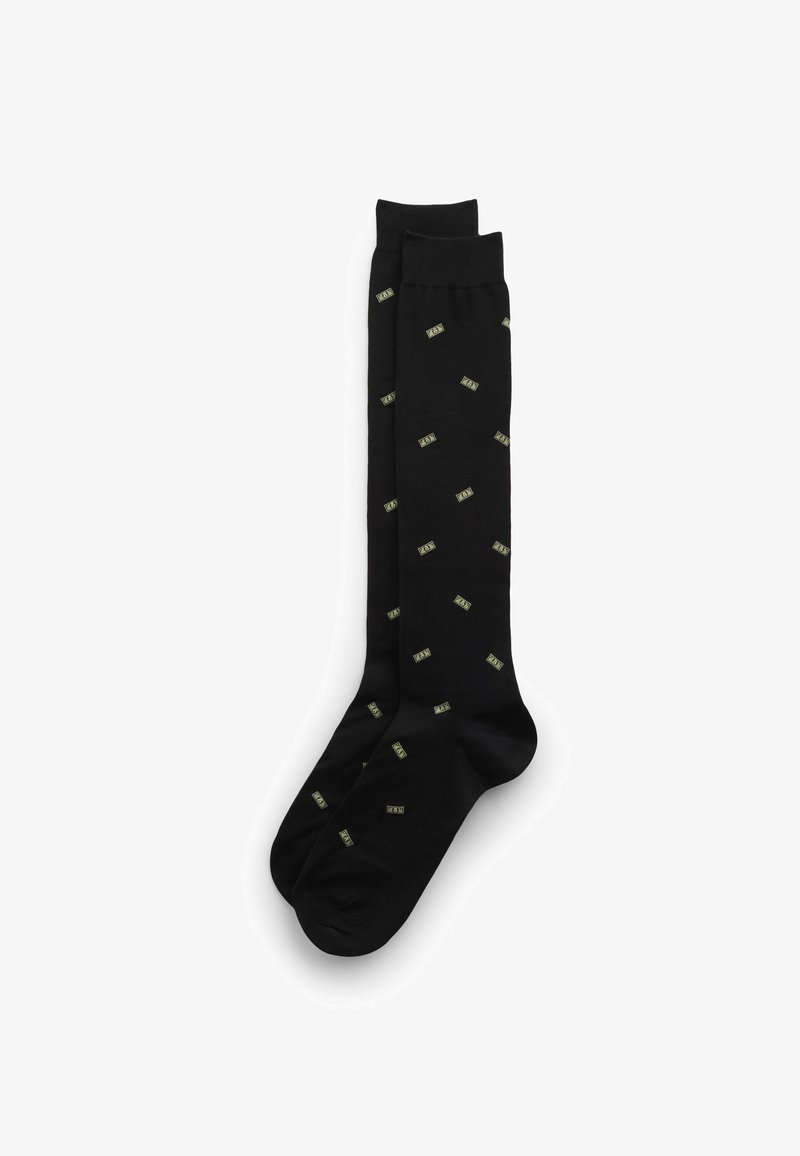 Chaussettes noires montantes jusqu'aux genoux avec un motif répété de billets de dollar verts, fabriquées dans un tissu lisse au toucher doux.