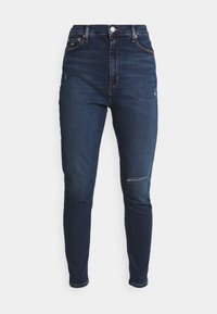 Jeans de corte alto y ajustado en denim azul oscuro con ligero desgaste, que cuentan con un cierre de botón en la parte delantera y un diseño clásico de cinco bolsillos.