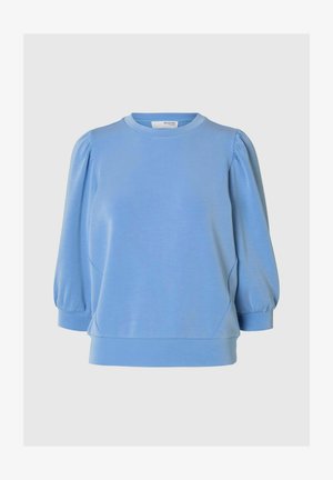 Hele sinine spordisärk ümmarguse kaelusega, puhv-õlgade ja liibuva hemiga. Valmistatud pehmest kangast, millel on kerge läige.