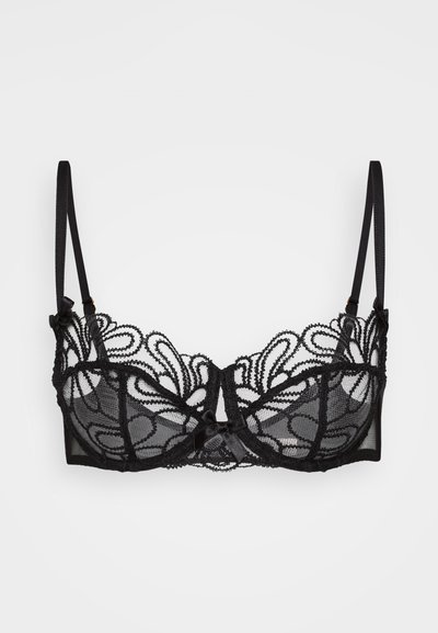 Sutiã de renda preta com um design floral e padrões intrincados, tecido transparente, alças ajustáveis e um pequeno laço de seda ao centro.