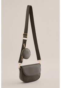 Borsa a tracolla in pelle verde scuro con una pochette tonda e rimovibile, presenta una chiusura con patta e accenti in metallo dorato.