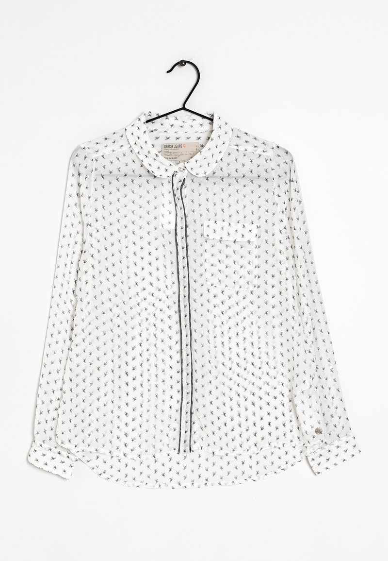 Biała przezroczysta koszula z guzikami z czarnym kwiatowym wzorem, spiczastym kołnierzykiem, przednią kieszonką i czarnym obszyciem wzdłuż listwy guzikowej oraz rękawów.