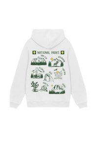 White hoodie with green illustrations and names of seven national parks, including Grand Teton, Yellowstone, and Yosemite.