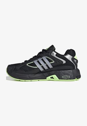 Scarpa da ginnastica Adidas nera e verde neon con pannelli in mesh, tre strisce argentate sul lato e suola testurizzata con etichetta "pro-moderator".