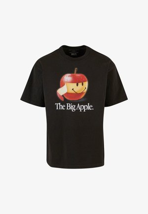 T-shirt en coton noir présentant un grand graphique d'une pomme souriante avec une peau rouge, un visage jaune et le texte "La Grande Pomme".