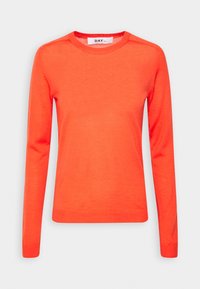 Pull crewneck orange vif avec des manches longues. Fabriqué en tissu doux, avec des poignets et un ourlet côtelés. Design simple sans motifs.