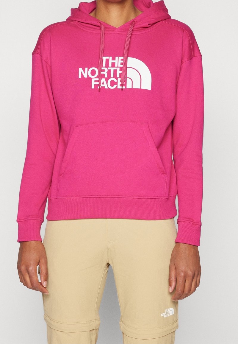 Sudadera con capucha rosa de mezcla de algodón, con un gran logo blanco en el frente, bolsillo delantero y capucha con cordón. Textura lisa.