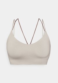 Lichtbeige bralette met een gladde textuur, voorzien van dunne verstelbare bandjes en een ronde hals. Accenten omvatten een contrasterend slank bandje.