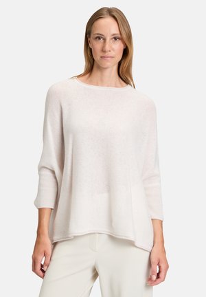 Lightweight, cream-colored sweater with a round neckline and 3/4 sleeves. Soft texture, relaxed fit, and subtle ribbed accents at the cuffs.