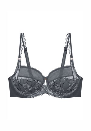 Svart spetsbehå med blommönster, genomskinliga kupor, volangiga band och ribbad midja. Har en liten roséguldsdetalj i mitten.