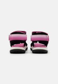 Pink and black sandals with adjustable straps, cushioned footbed, and rubber outsole. Rear view showcasing dual-tone design and sturdy construction.