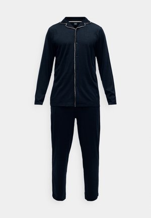 Completo pigiama blu navy realizzato in tessuto morbido. Maglietta a maniche lunghe con chiusura a bottoni e profilatura a contrasto; pantaloni abbinati con gambe affusolate.
