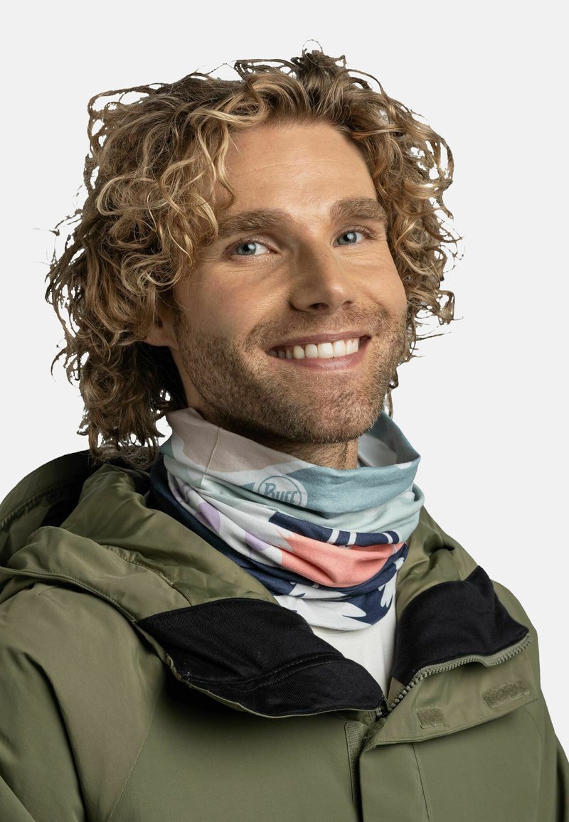 Multifunctional neck gaiter made of lightweight fabric, featuring a mix of pastel colors and abstract patterns, worn under a green jacket.