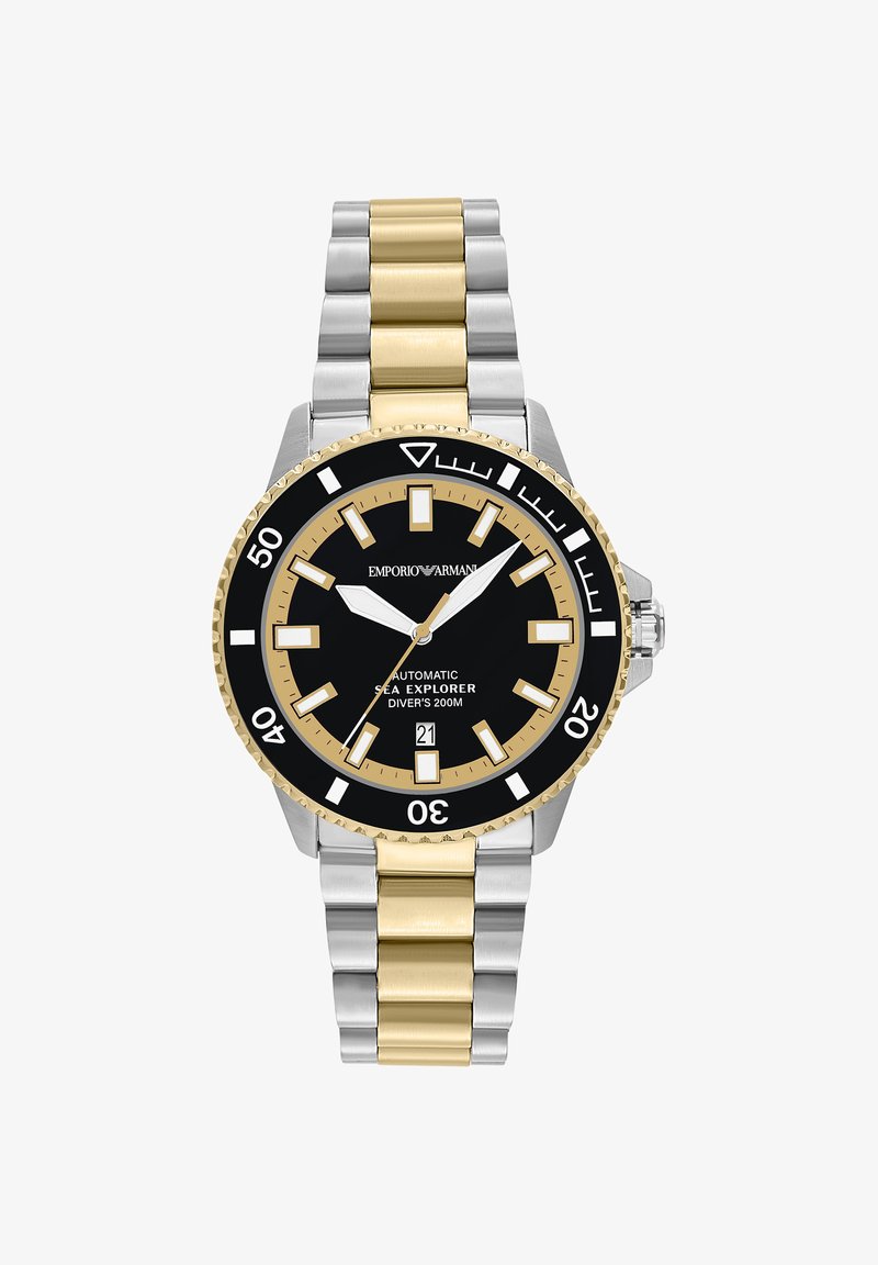 Montre de plongée en métal bicolore argent et or avec cadran noir, aiguilles lumineuses, affichage de la date et lunette tournante marquée jusqu'à 50 minutes.