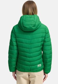 Green puffer jacket with a hood, featuring horizontal quilted sections and a small logo patch at the hem. Smooth texture and lightweight design.