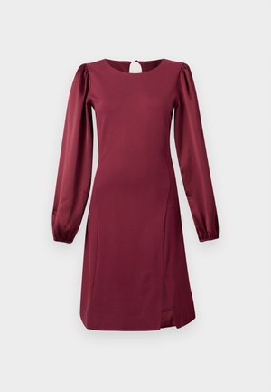 Abito bordeaux con maniche lunghe a sbuffo, scollatura rotonda, dettaglio con apertura a chiave sul retro e spacchetto laterale per un tocco di design in più. Realizzato in tessuto morbido.