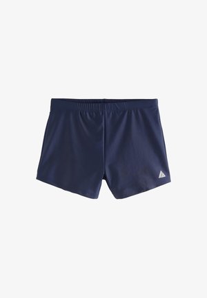 Pánske plavkové šortky námorníckej modrej farby s elastickým pásom a malým bielym trojuholníkovým logom na spodnej pravej strane nohy.