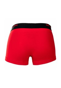 Red boxer briefs with a black waistband featuring the "HUGO" logo in red. Made from a smooth, stretchable fabric.