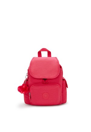 Red backpack made of textured fabric, featuring a flap closure, front pocket, side pockets, and a monkey keychain accessory.