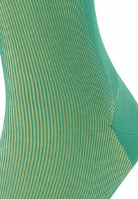 Grüne und goldene gestreifte Socken mit geripptem Design und verstärkter Ferse. Glattes Material mit kontrastierenden Farbtönen.