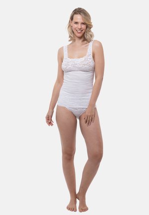 White lace-trimmed tank top with thin straps and a fitted shape, paired with matching lace-accented underwear, displayed on a neutral background.