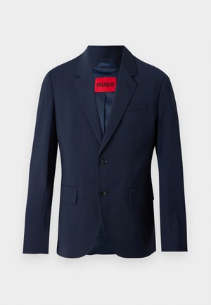 Navy blue blazer with two buttons, notch lapels, front pockets, and red branded label inside. Smooth fabric with a tailored fit.