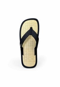 Black flip-flop with a woven bamboo footbed, featuring black textured straps and a central dot accent. Smooth edges and flat sole.
