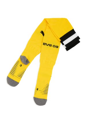 Żółte skarpety sportowe z szarymi palcami i piętami, czarno-białe paski u góry, napis "BVB 09" oraz logo Puma po bokach.