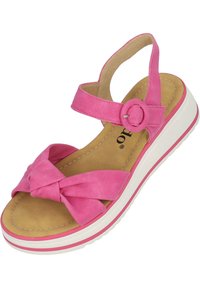 Sandalo di suede rosa con un dettaglio a nodo sulla parte anteriore, cinturino alla caviglia regolabile e suola piatta bianca con una linea accentata rosa.